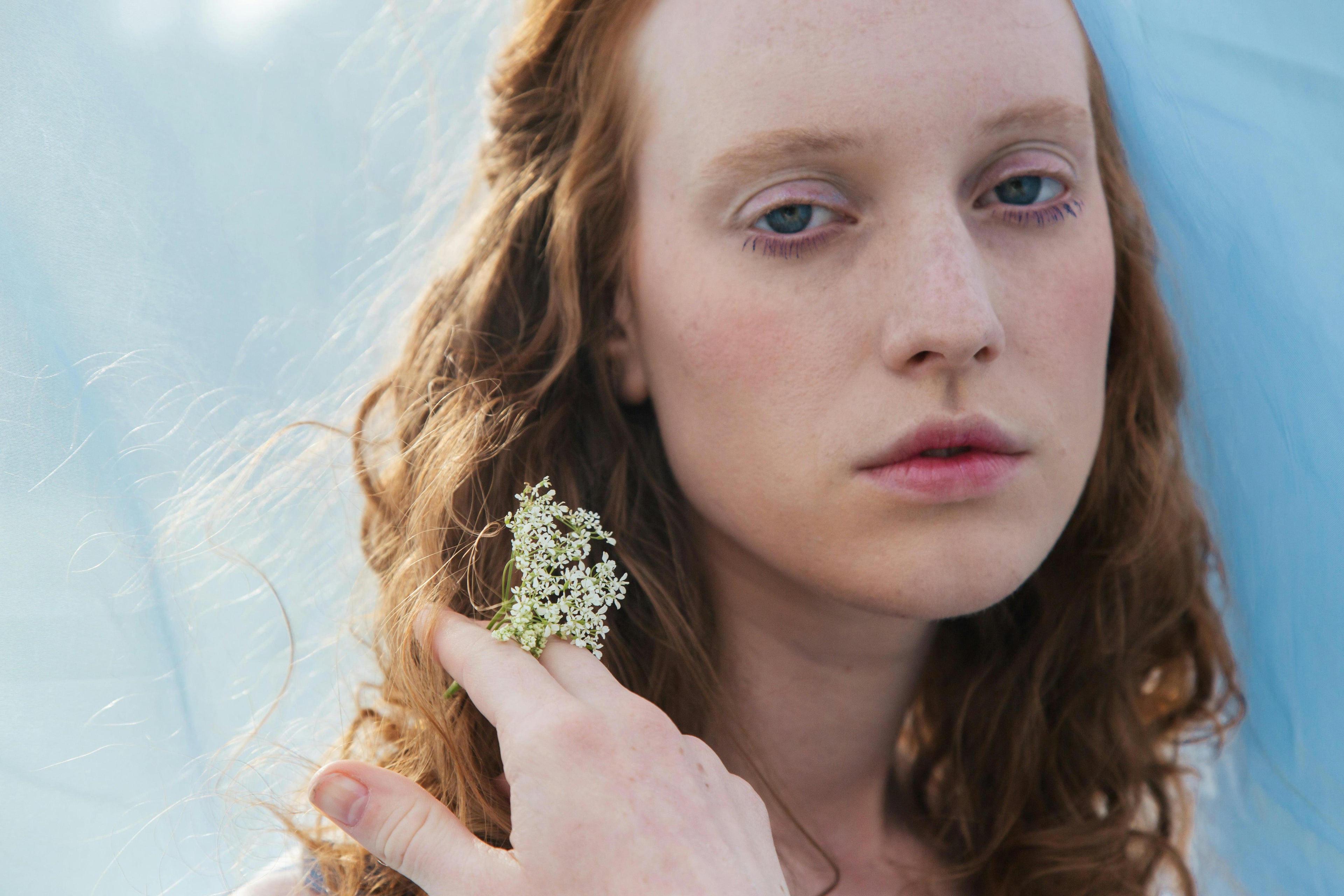 A girl with sensitive skin holding a flower