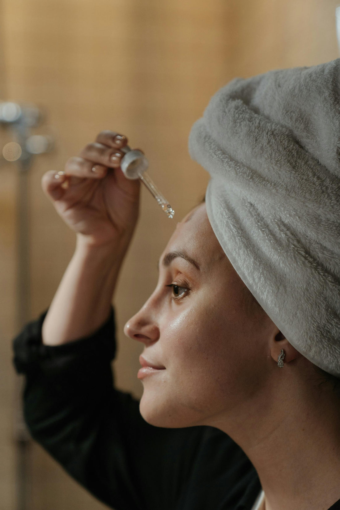 A Woman applying Serum on her face