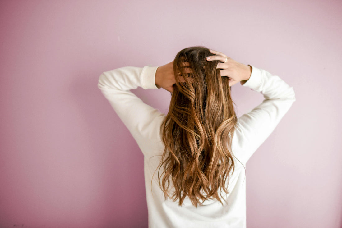 A girl holding her hair.