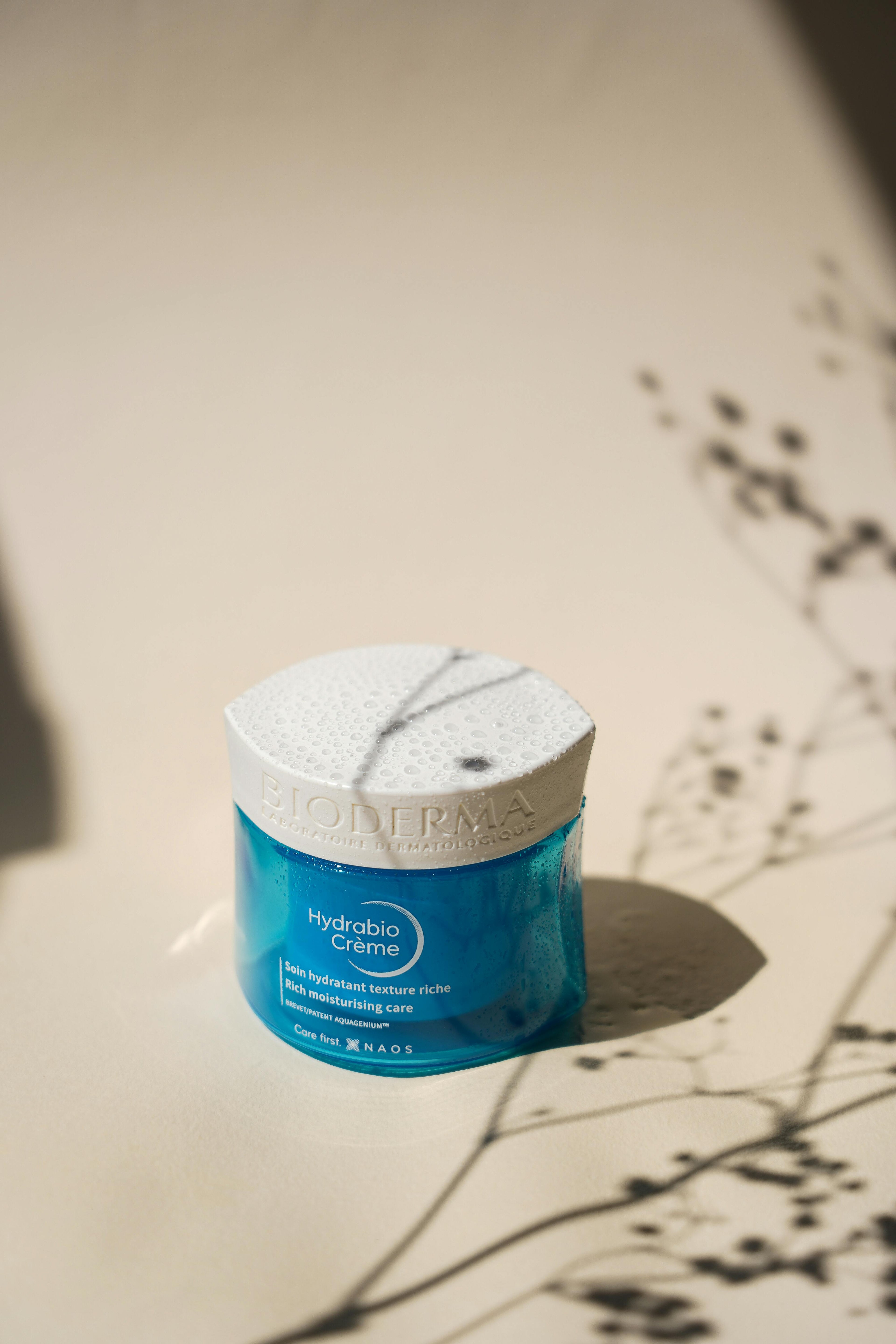 A jar of bioderma Hydrabio creme sitting under a shaded area