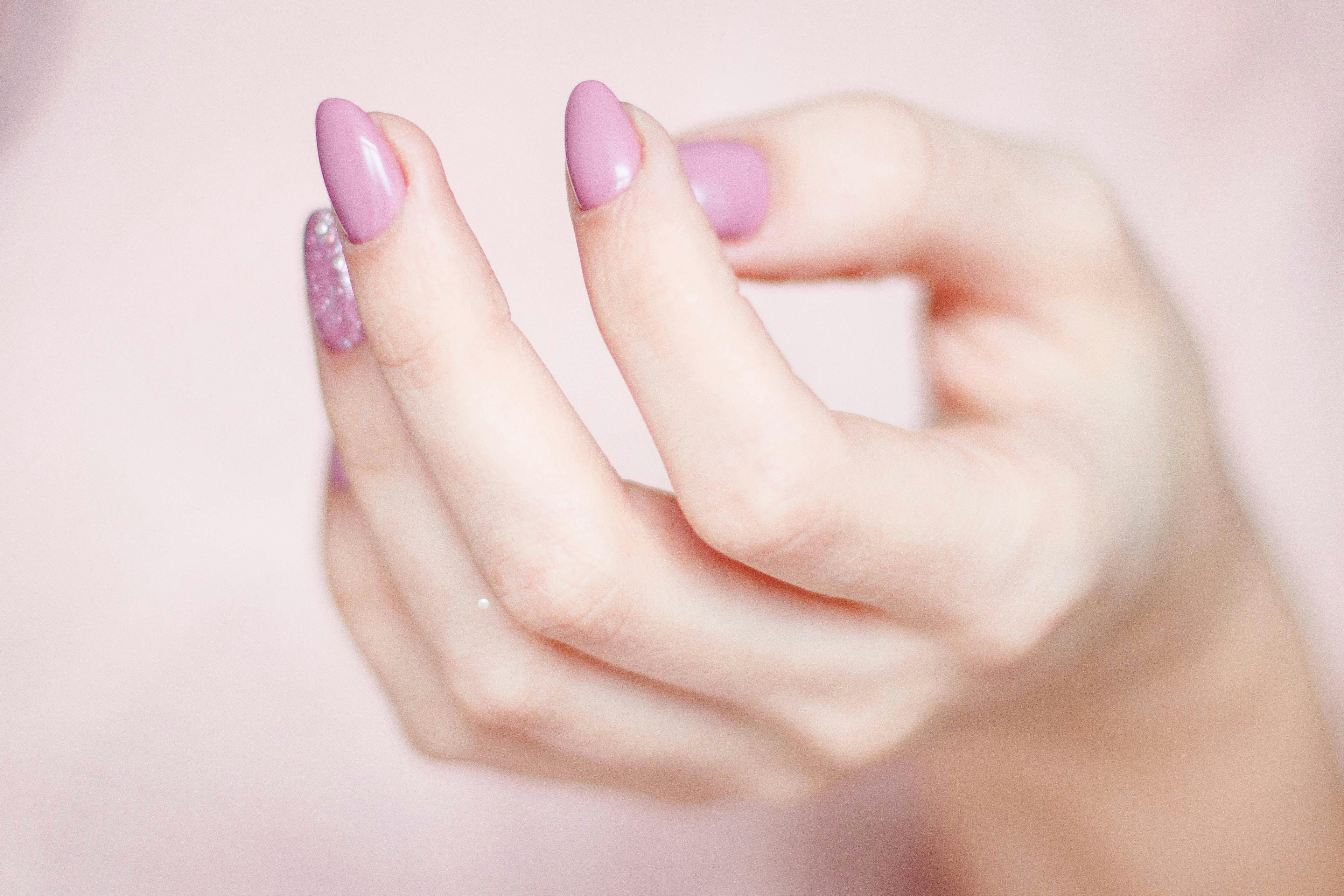 a woman with lilac colored nails