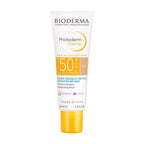 Bioderma Photoderm Crème sun cream tube on a beige background