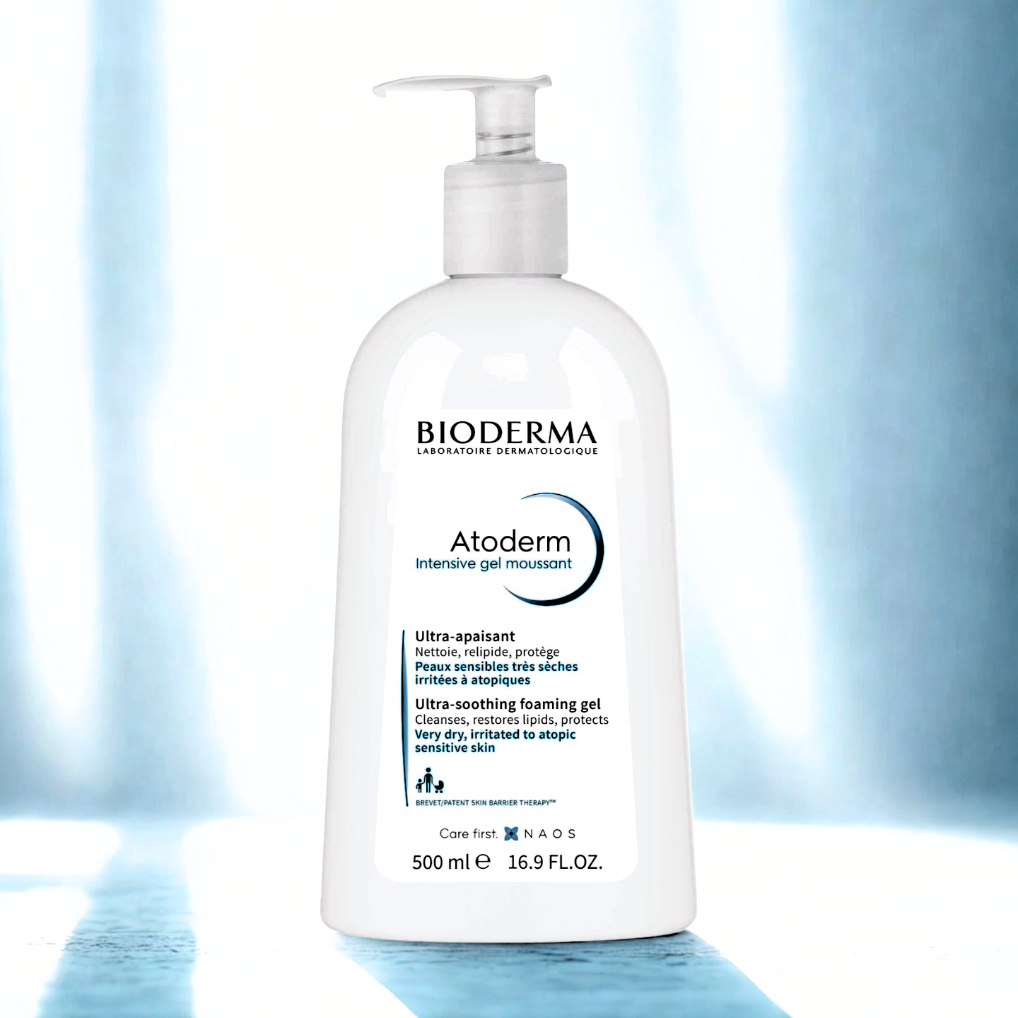 Bioderma Atoderm bottle on a blue gradient background