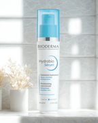 Bioderma Hydrabio Serum bottle on a white surface with a blurred background
