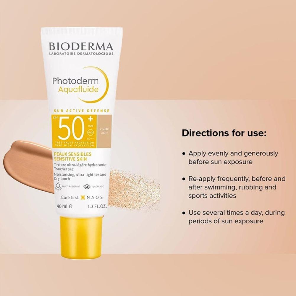 Bioderma Photoderm Aquafluide sunscreen bottle with application instructions on a beige background