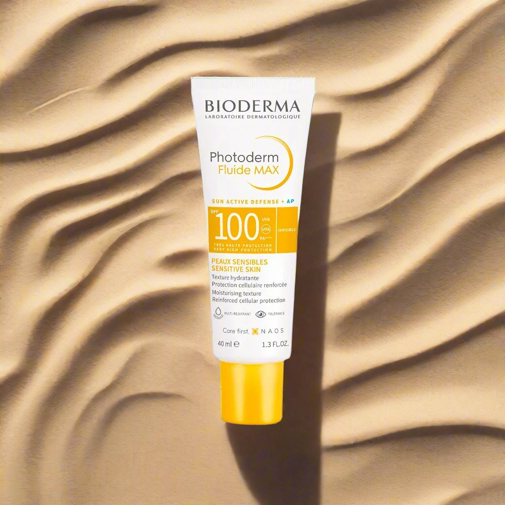 Bioderma Photoderm Fluide MAX sunscreen tube on a textured beige background