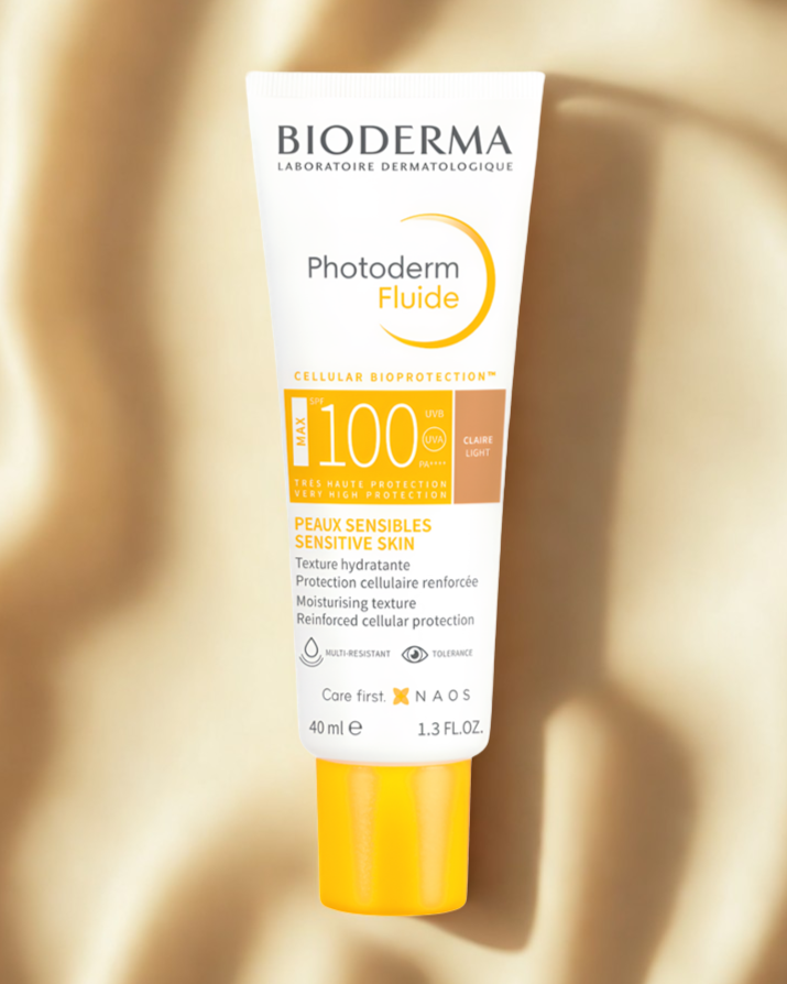 Bioderma Photoderm Fluide sunscreen bottle on a gold background