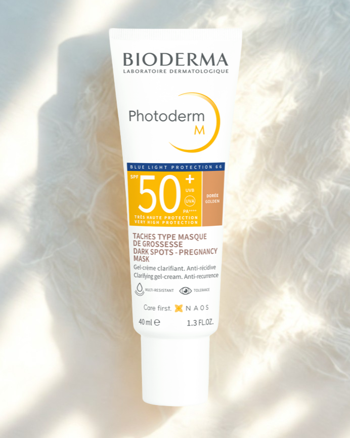 Bioderma Photoderm M sunscreen tube on a textured white background