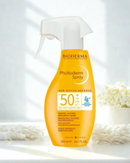 Bioderma Photoderm spray bottle on a white background