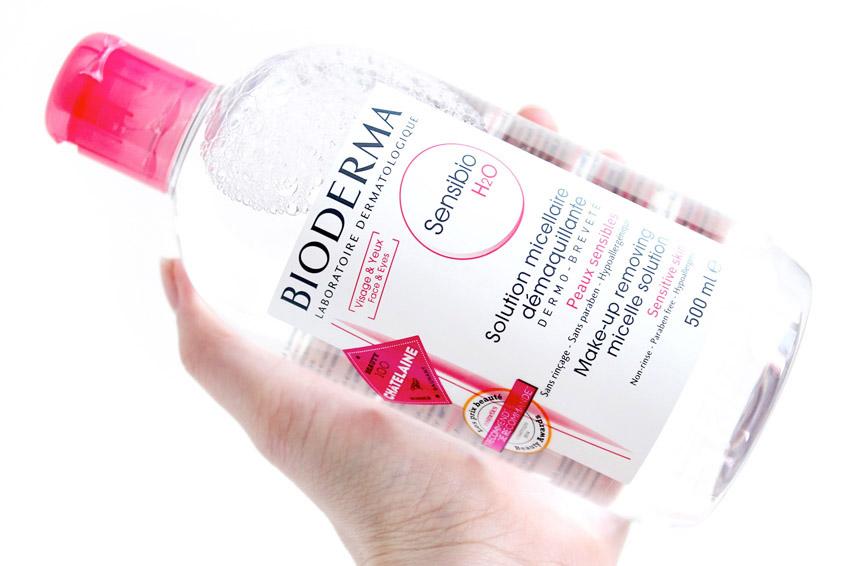 Bioderma Sensibio bottle held in a hand against a white background