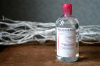 Bioderma bottle on a wooden surface with a dark background