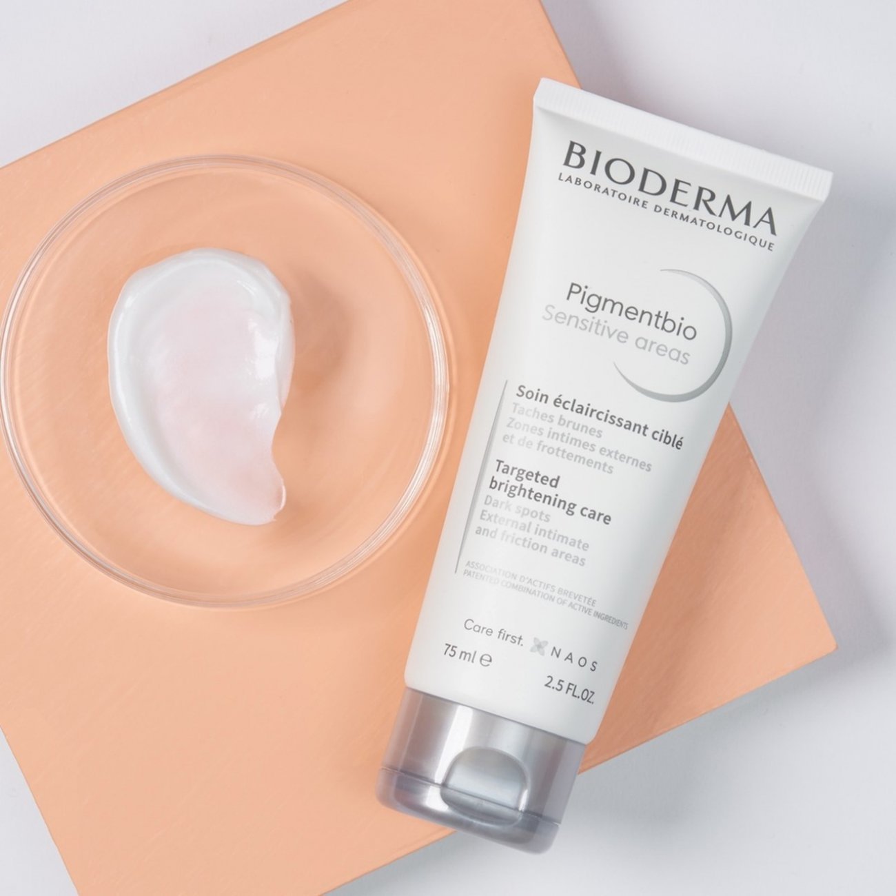 Bioderma skincare product with a small amount of cream on a peach-colored mat