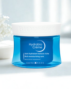 Blue jar of Hydrabio Creme with white lid on a light background