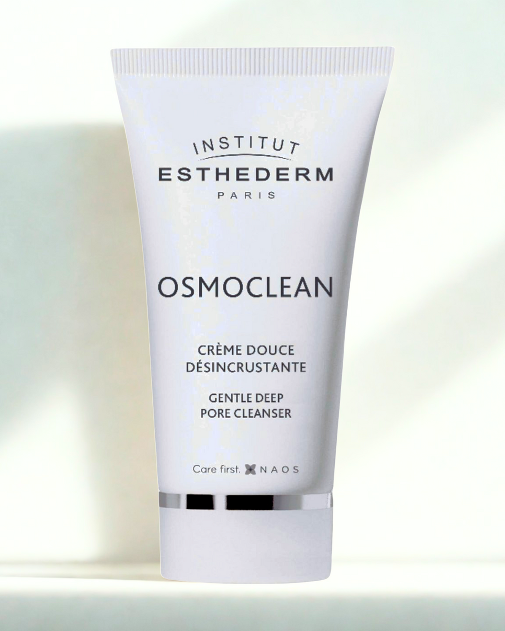 Institut Esthederm Osmoclean cream tube on a gradient background