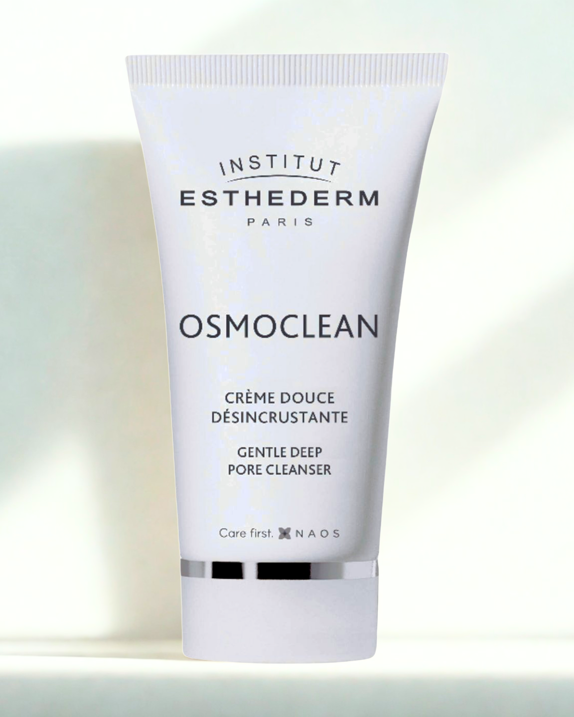 Institut Esthederm Osmoclean cream tube on a gradient background